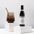 Glass of drink more good's classic cola syrup prepared as a soda.